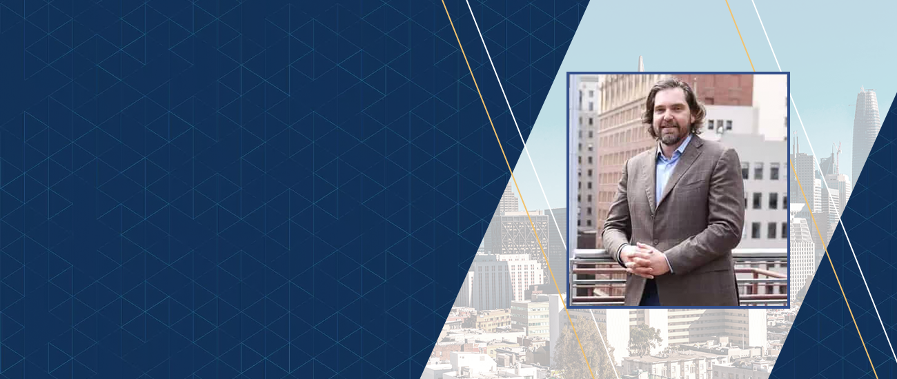 Picture of Alex Kugelman with a city skyline featuring various buildings